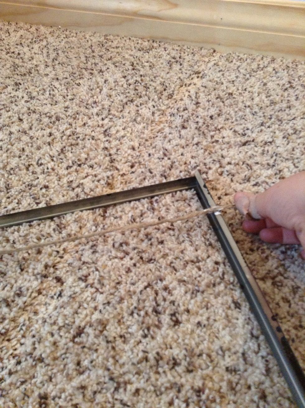 Glue the ribbon or twine to the back of the frame if I did it again I would use hot glue!