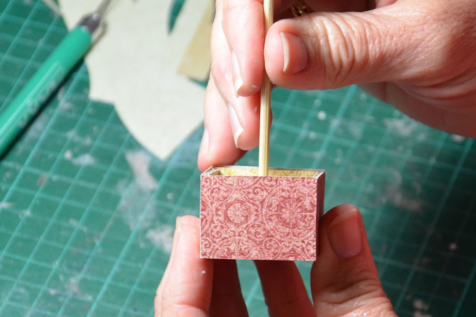 Glue the skewer into the centre hole of the basket.