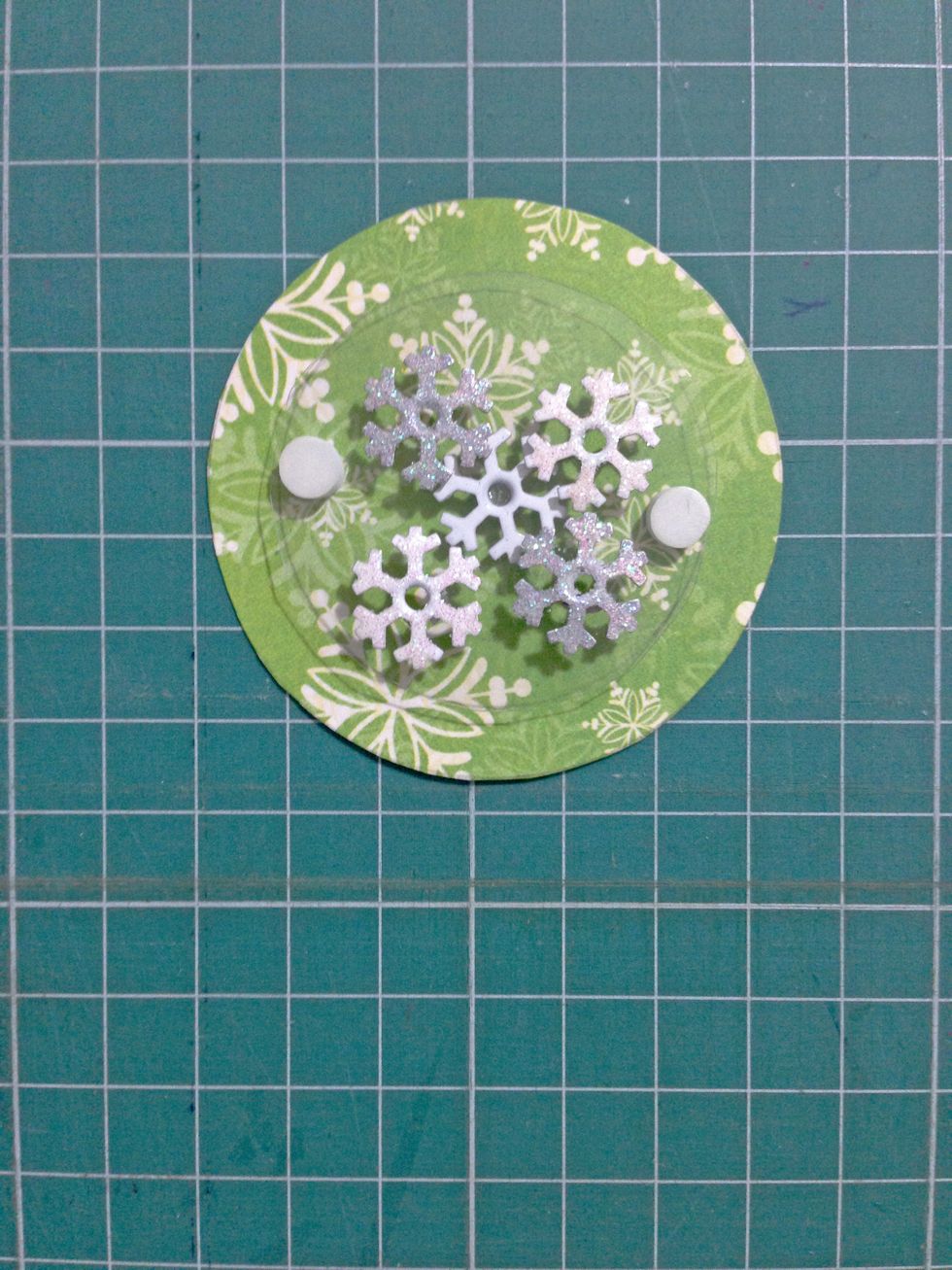 Glue the snowflake brads (or gems) in between one of the circle (without the hole) and acetate sheet...