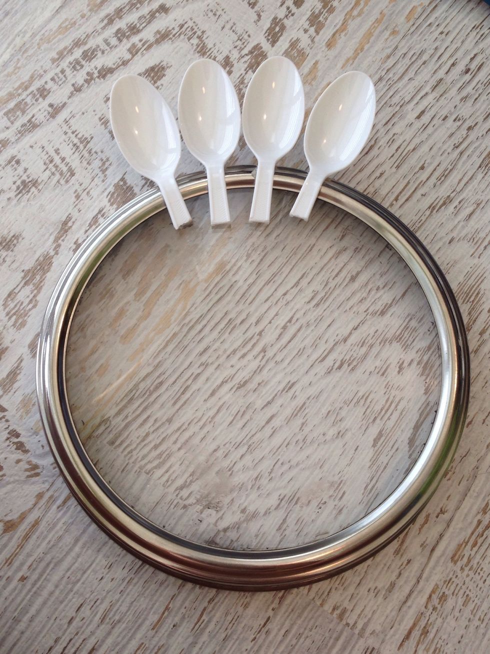 Glue the spoons around the edge of the base