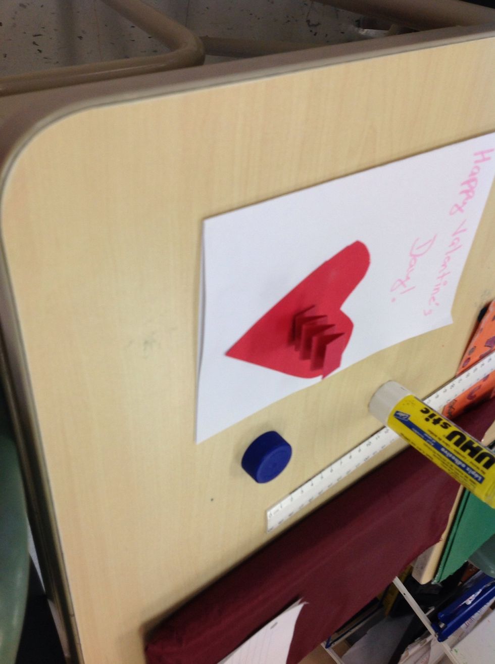 Glue the spring on the middle of the heart.