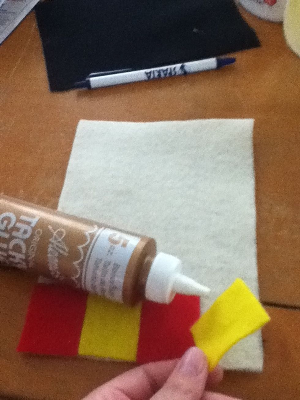 Glue the squares on the bottom to make Harry's scarf with heavy duty glue.