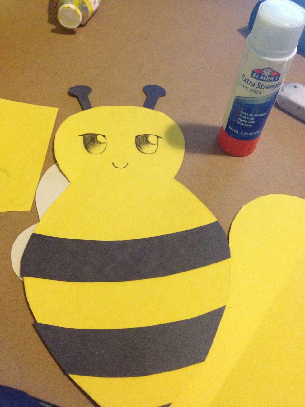 Glue the stripes on top, the antennas behind the head and we'll glue the wings on later.