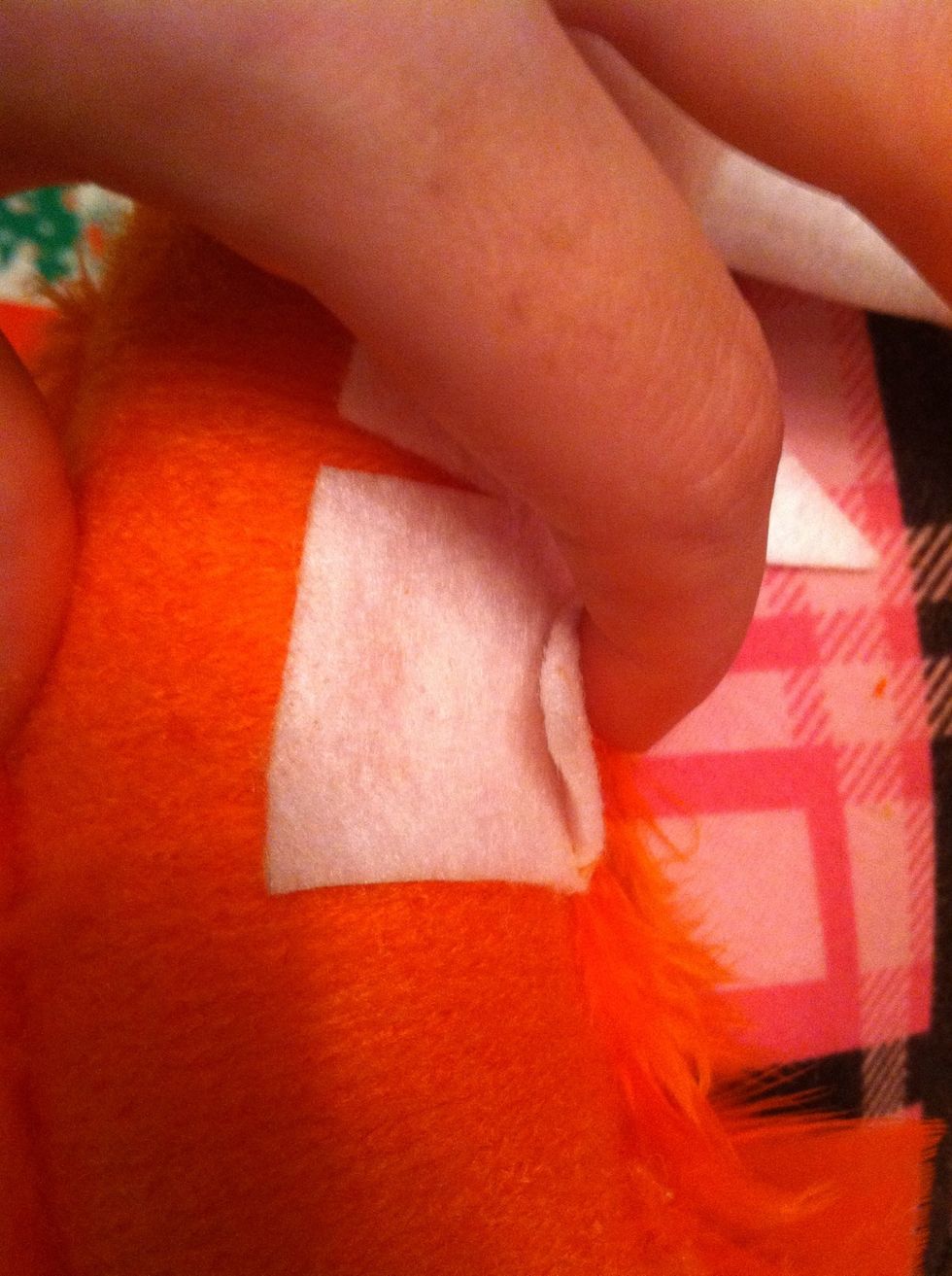 Glue the teeth on and put a little dab of hot glue behind each tooth. Hold it in place til the glue dries. This will make sure the teeth are vertical instead of sticking straight out.