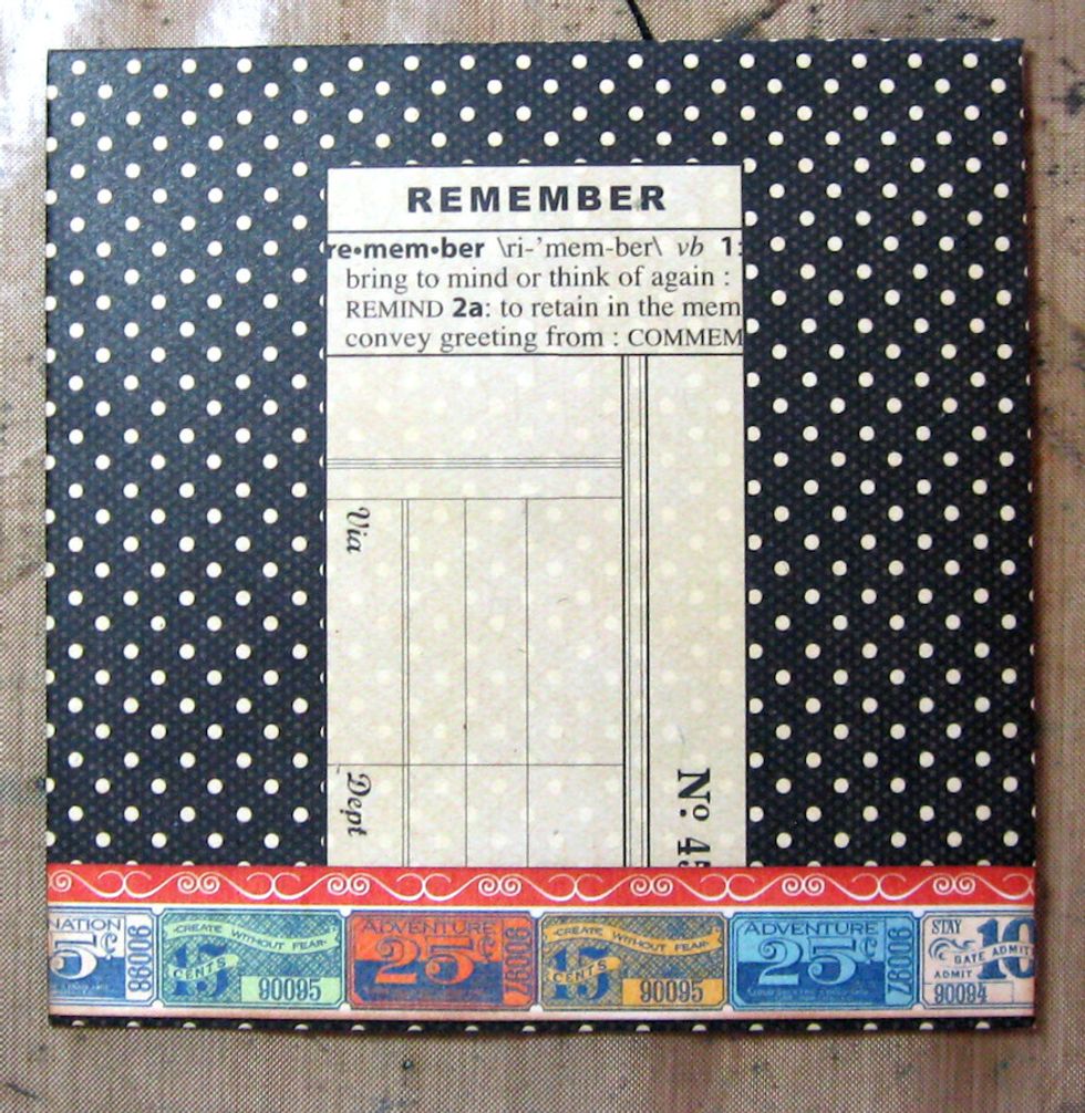 Glue the ticket strip to the base of the envelope, leaving a small border of black.