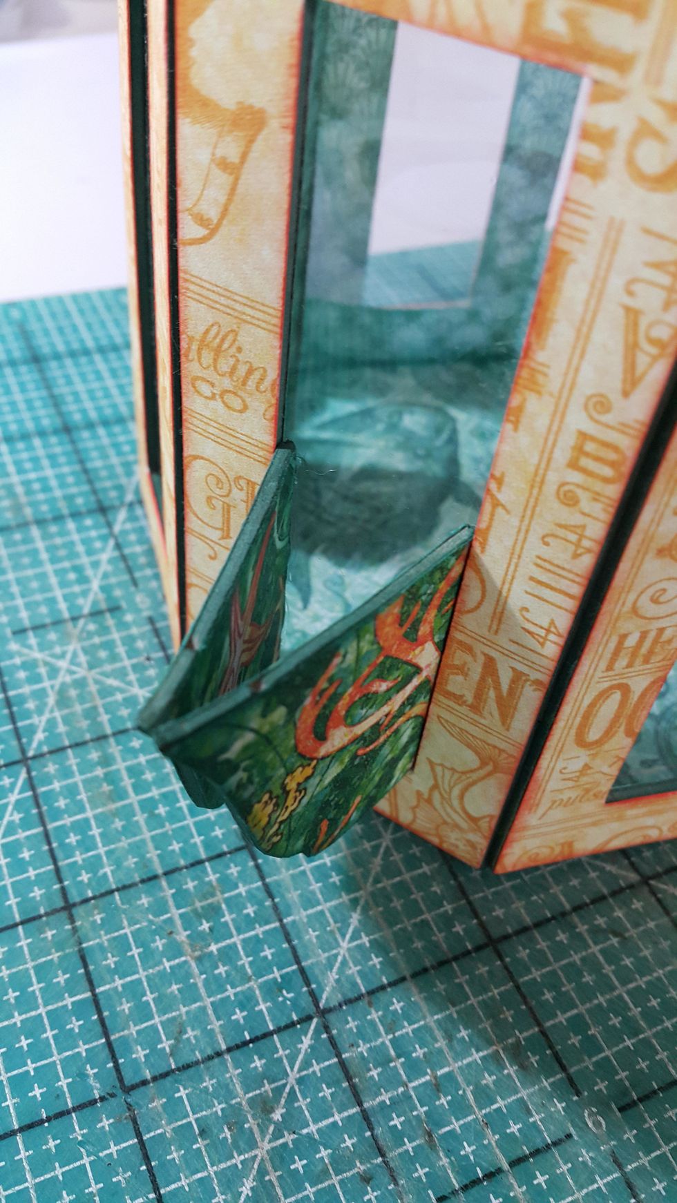 Glue the tips and handles by the edges of the window as shown.