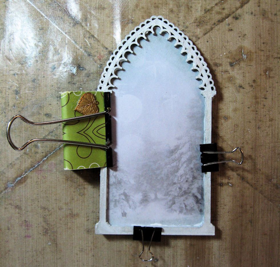 Glue the top and bottom of the frame together.  Hold in place while the glue dries.  Then proceed to build your winter scene.  Start by gluing the tree to the base of the arch.