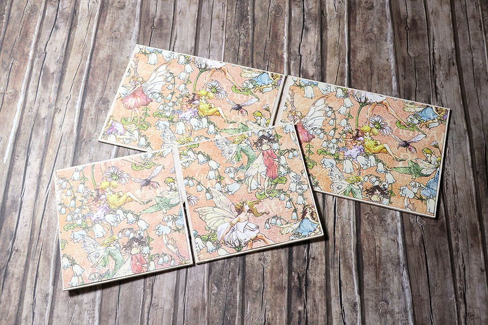 Glue them down to the chipboard separators that we've prepared earlier and painted with the acrylic paint. Mind the direction of the paper.