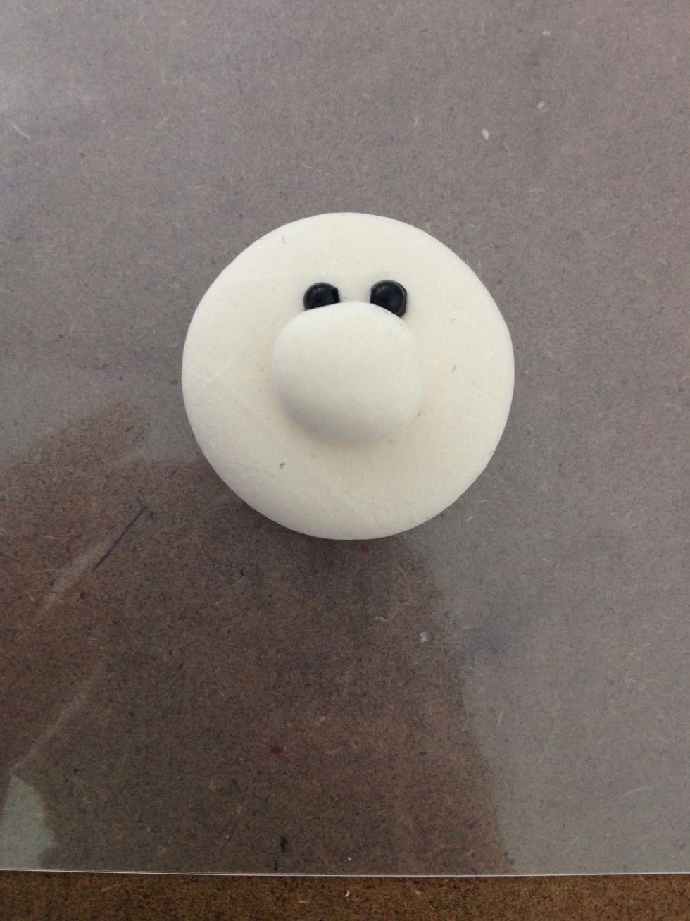 Glue them together and also glue the two beads as eyes.
