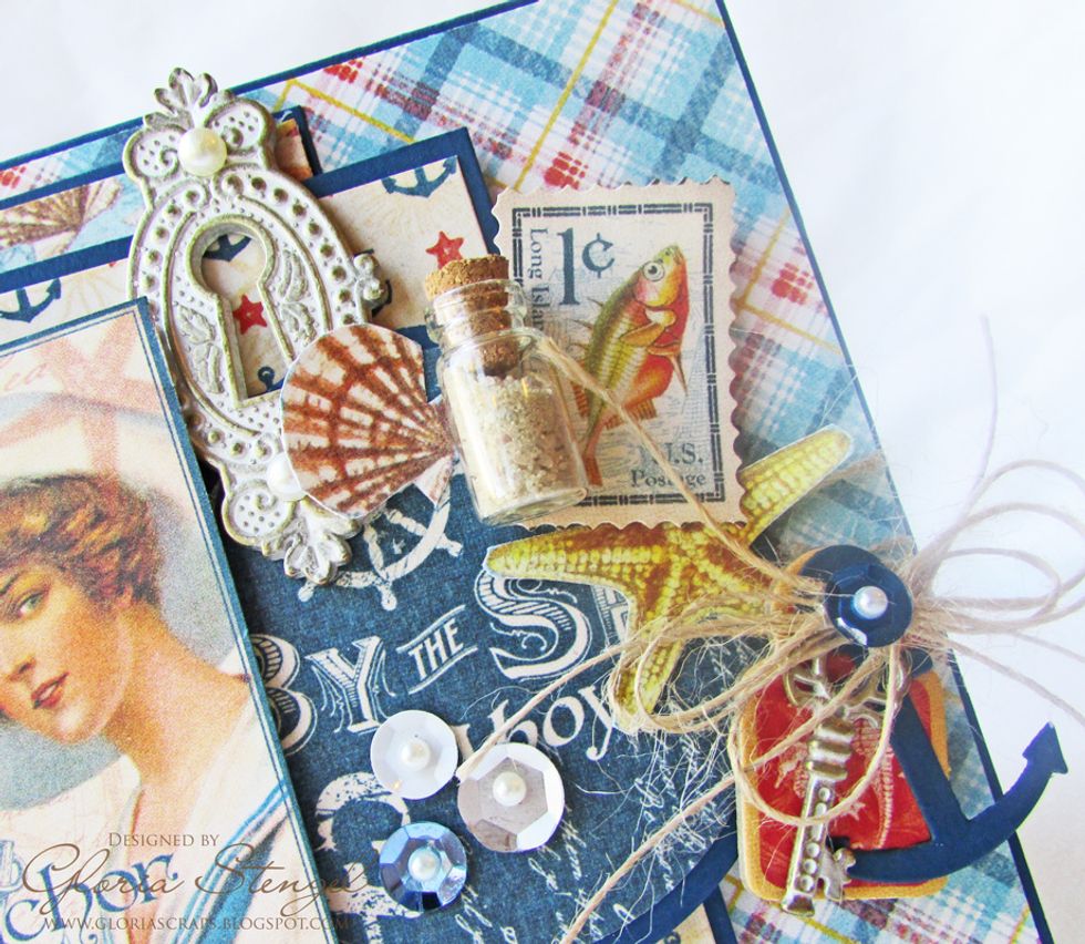 Glue three sequins to the Set Sail circle. Add a self-adhesive pearl to the top of each sequin. Glue a Key Hole to right edge of the main image. Add self-adhesive pearls to the keyhole as shown.