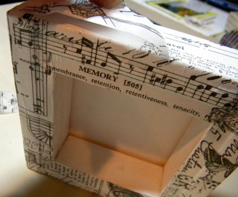 Glue Tim Holtz tissue wrap to the sides and front of the canvas using matte medium.