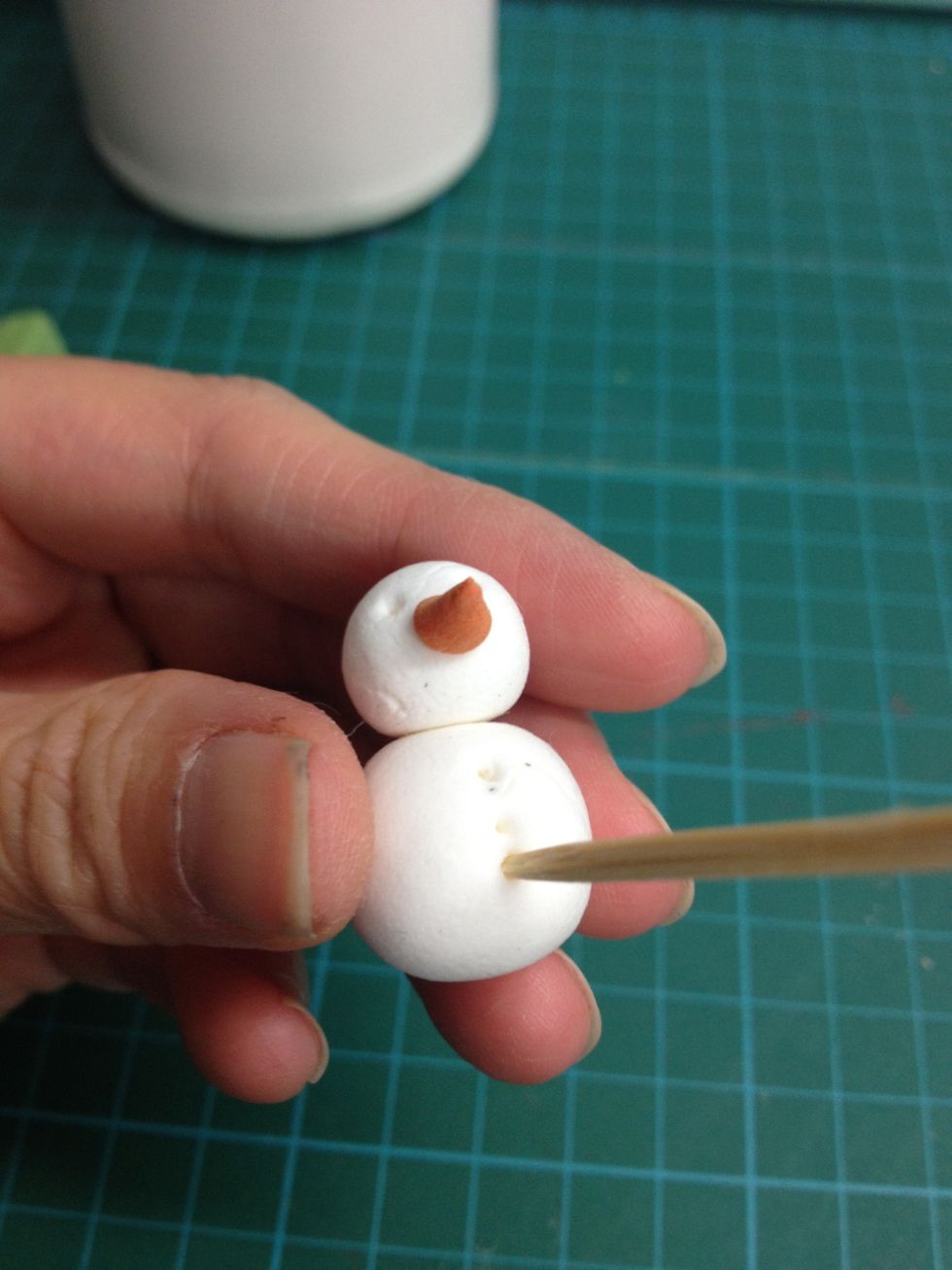 Glue to the body and then pin 3 holes as the buttons.