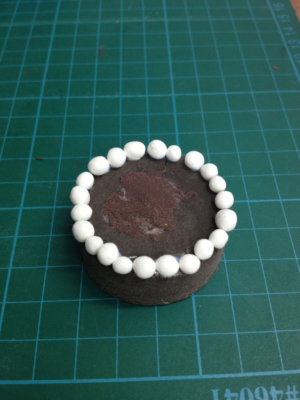 Glue white balls around.