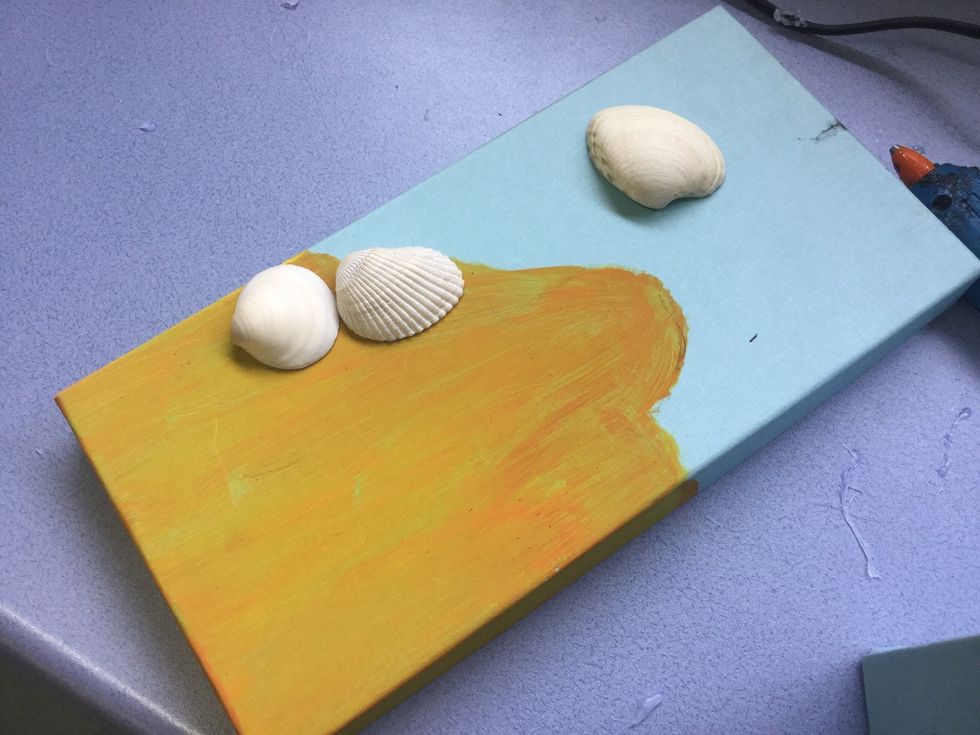Glue your shells down.I placed 2 shells on the beach. ( the one in the water isn't stuck down)