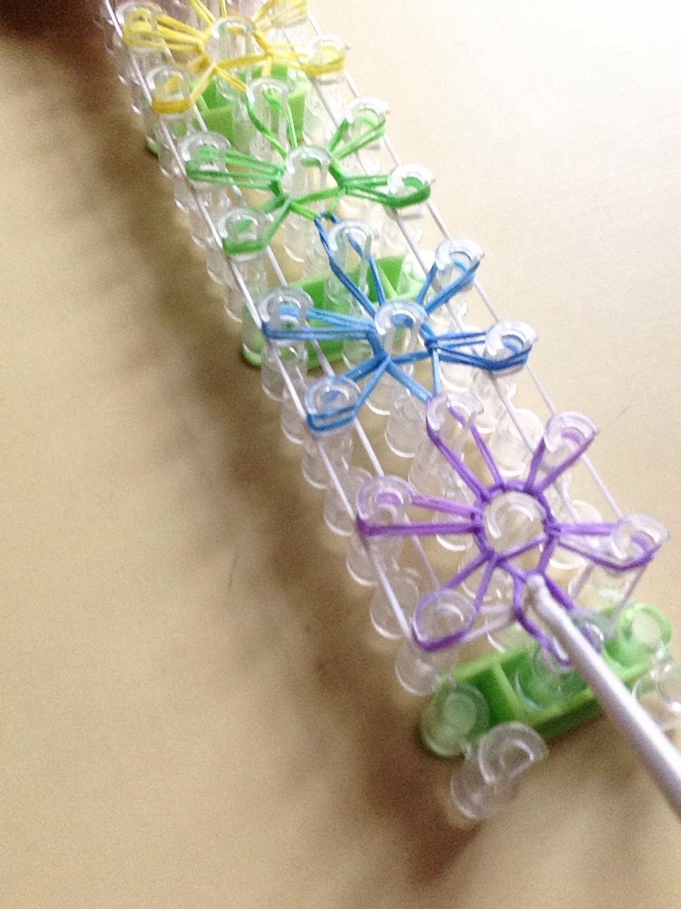 Go all the way back to the bottom and pull underneath the captain Band and then pull over the white one on top to the one on the side.