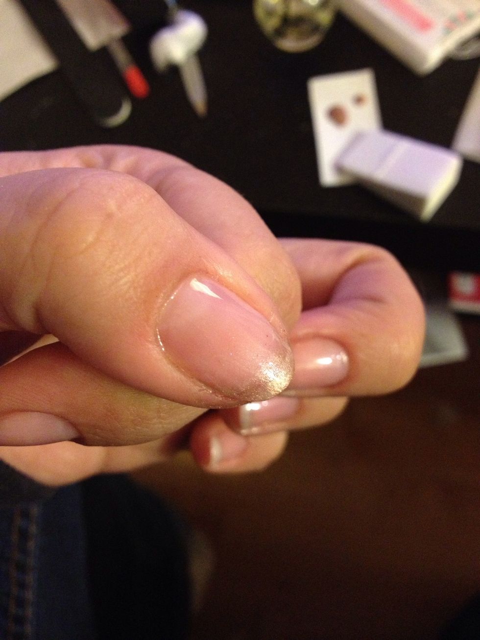 Go around the edge of your fingernail. Then with a clean edge of the sponge, dab down to fade it...