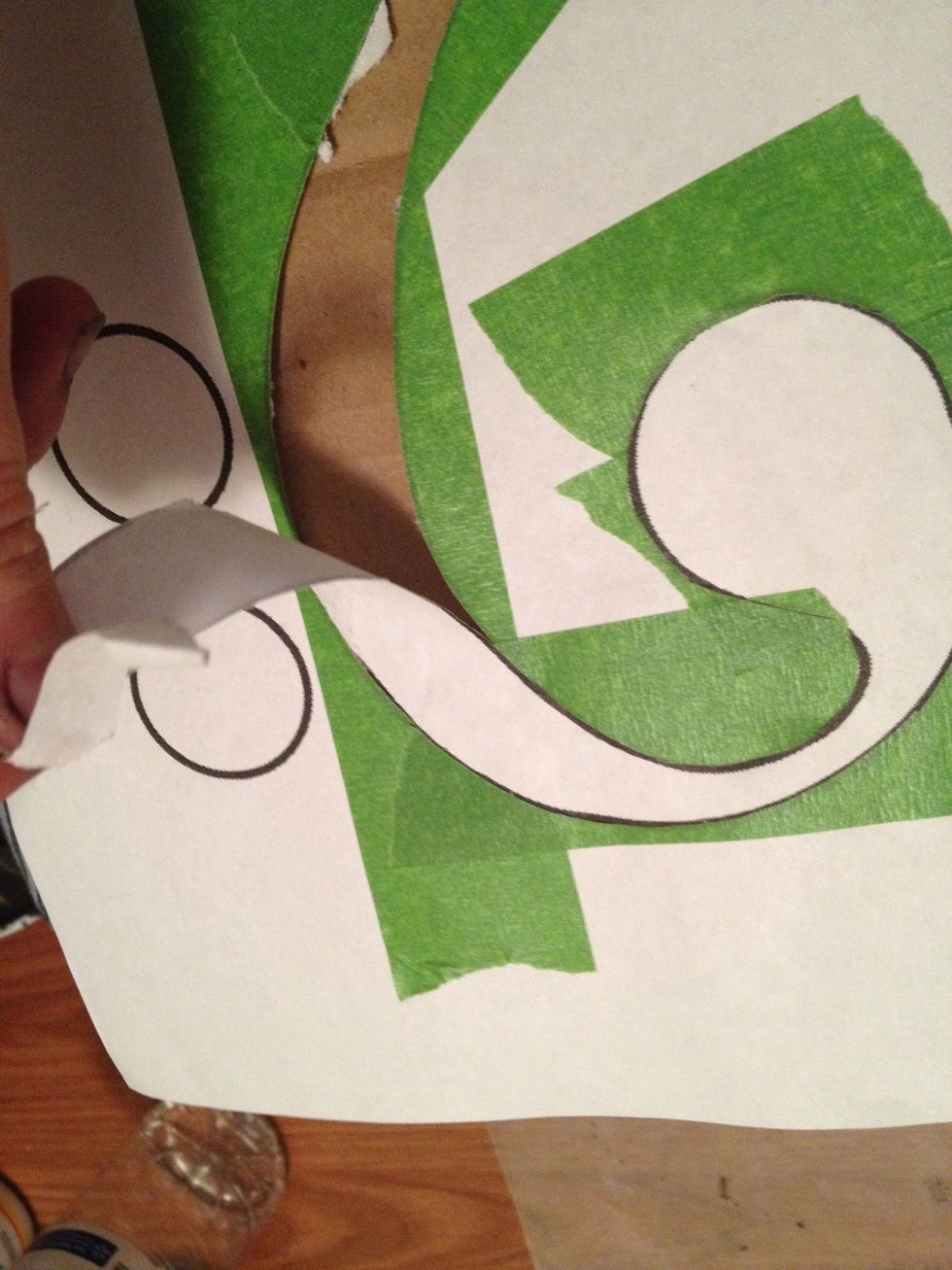 Go back to your stencil and remove the paper under the painters tape we removed earlier. You may need to cut it in some places.