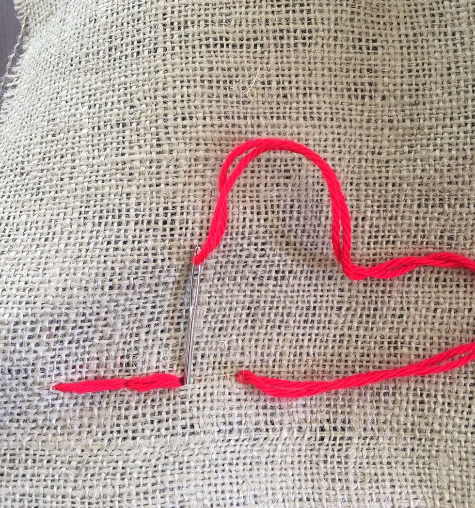 Go backwards with your stitch. Go down in the same hole as the end of your last stitch.