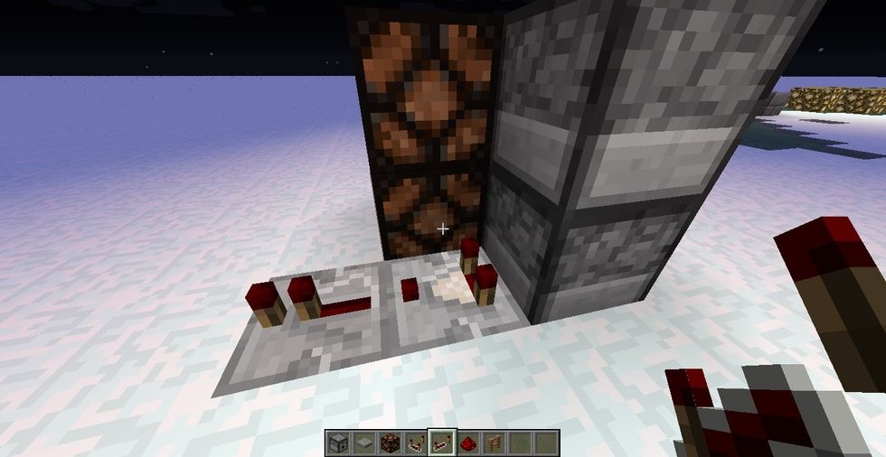 go behind to the left dispenser and place redstone comparator coming out from bottom dispenser and put repeater coming out from comparator.