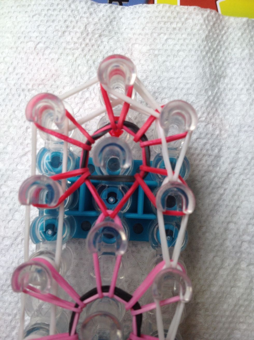 Go diagonal to the last peg. Go back to the bottom of the loom ad loop back up to the top, go diagonal again.