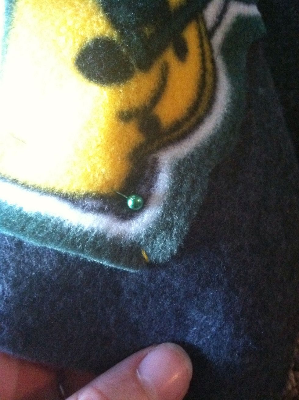 Go down at the edge of the appliqu\u00e9 through both pieces of fabric.