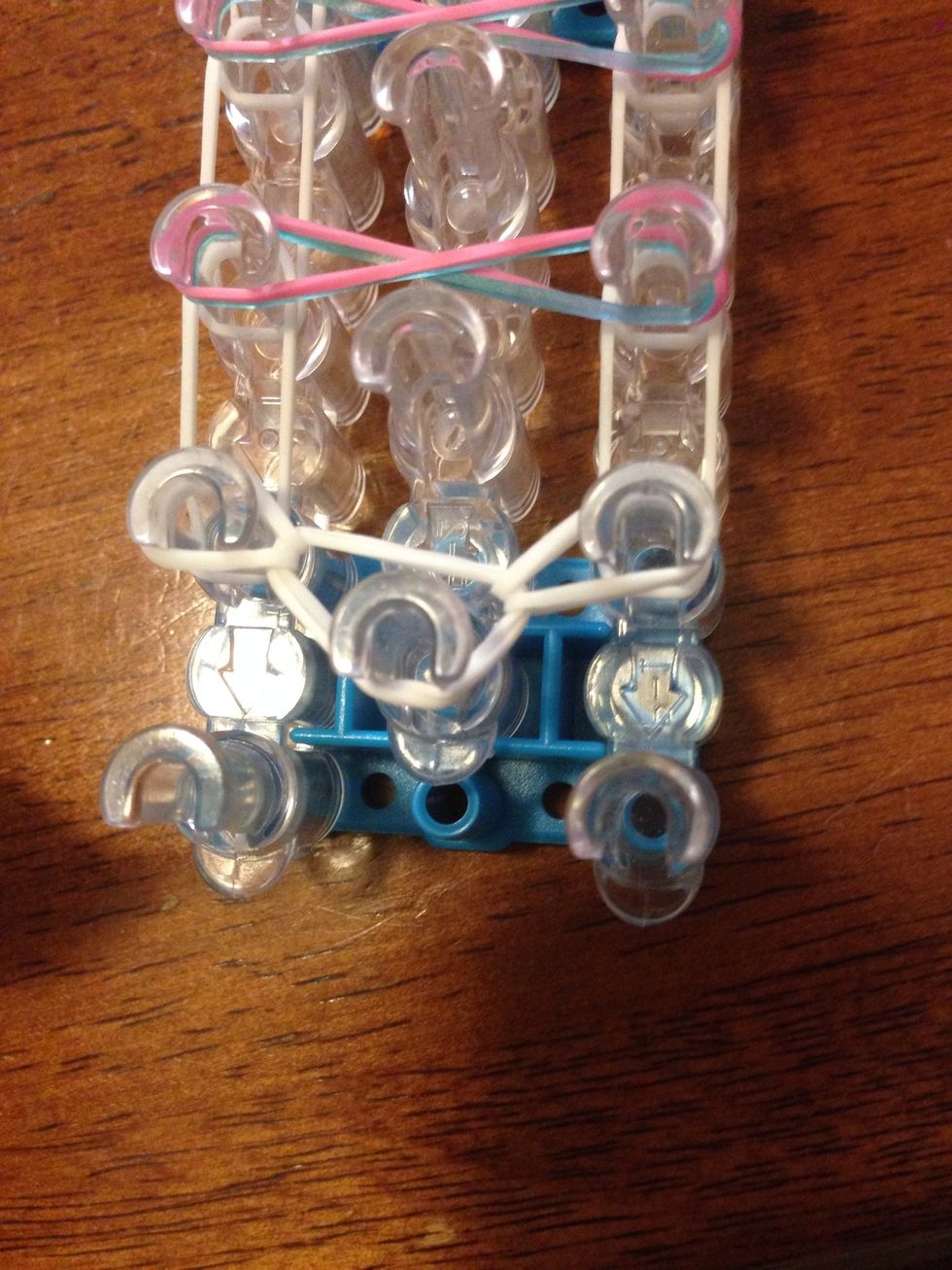 Go inside the cap band again, and stretch the last band over to the right pin.