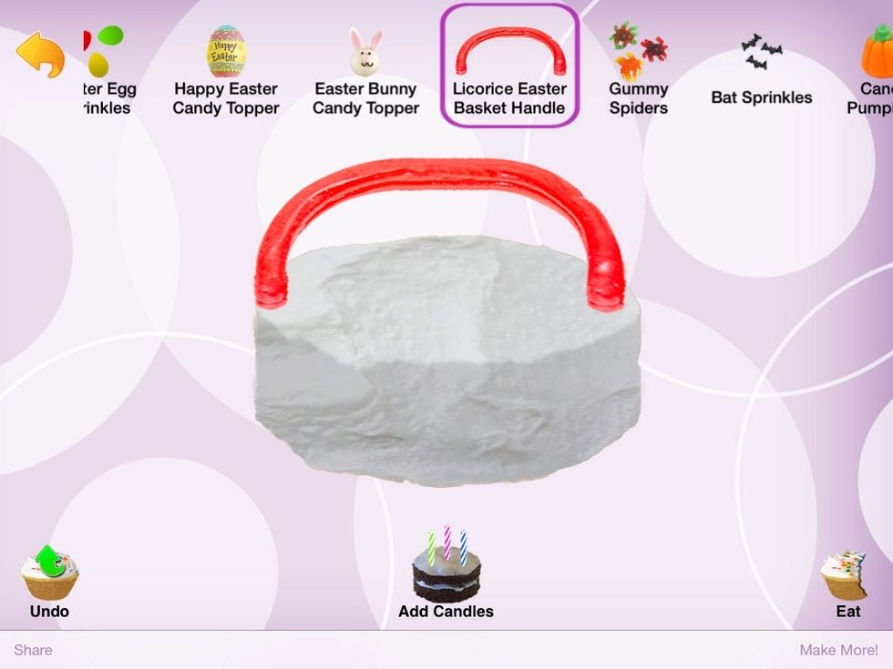 Go into decorations and find the "Licorice Easter Basket Handle" and just tap the very tippy top of the cake right in the middle so it shows up like this. I doesn't have to be perfect. Mine isn't.
