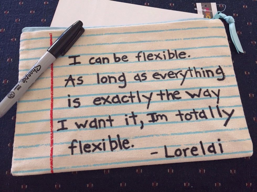 Go over quote with sharpie.  Be sure to put a piece of cardboard underneath top fabric so marker won't seep through.  Hold fabric taut while writing.