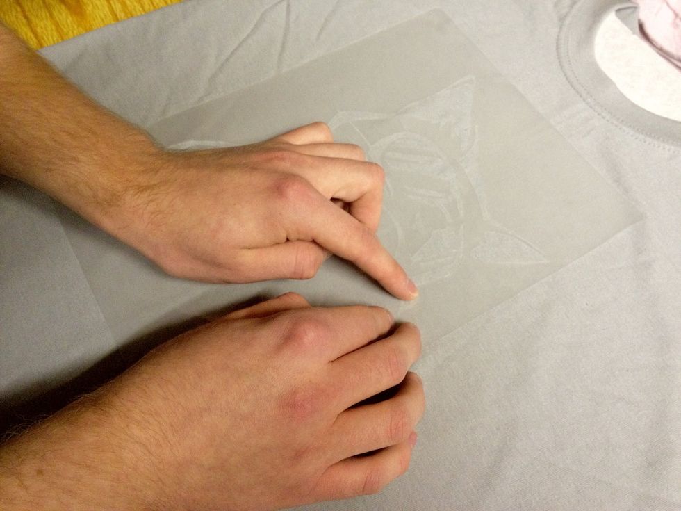 Go over the stencil with you fingers and make sure it's all stuck down. Be extra sure that any small pieces won't come up when you spray it and mess up your design.