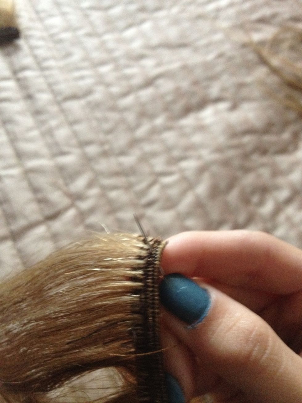 Go through the top of the extensions (where the cotton is). Where u want your clip to start