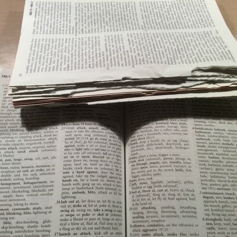 Go through your book and randomly remove sections of the pages to lessen the thickens of the book. You can use these pages for future projects.