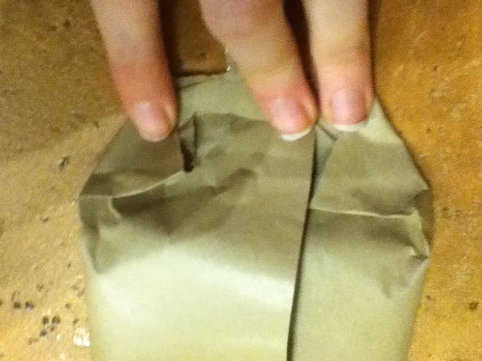 Go to one end and fold over the corners. (click picture for reference)