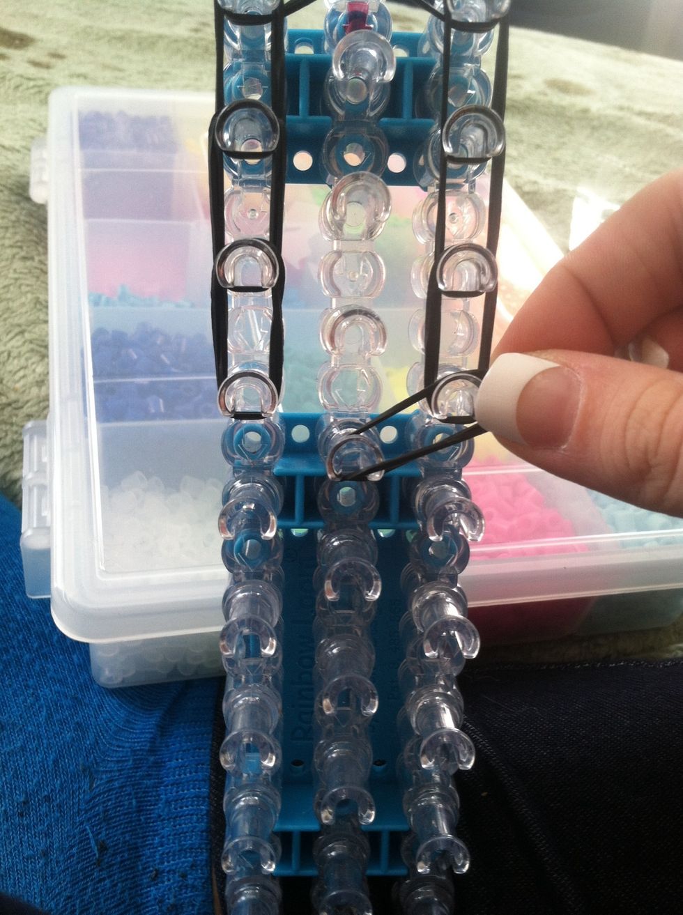 Go to the bottom of where you placed you bands on the right place a double band diagonal so it hooks in the the middle row.