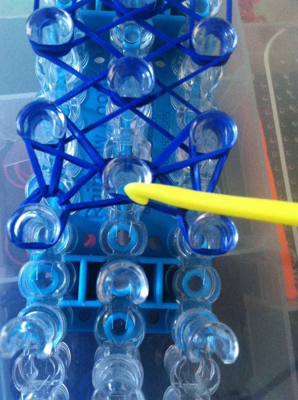 Go to the center pin take the top babd and loop it on to itself.
