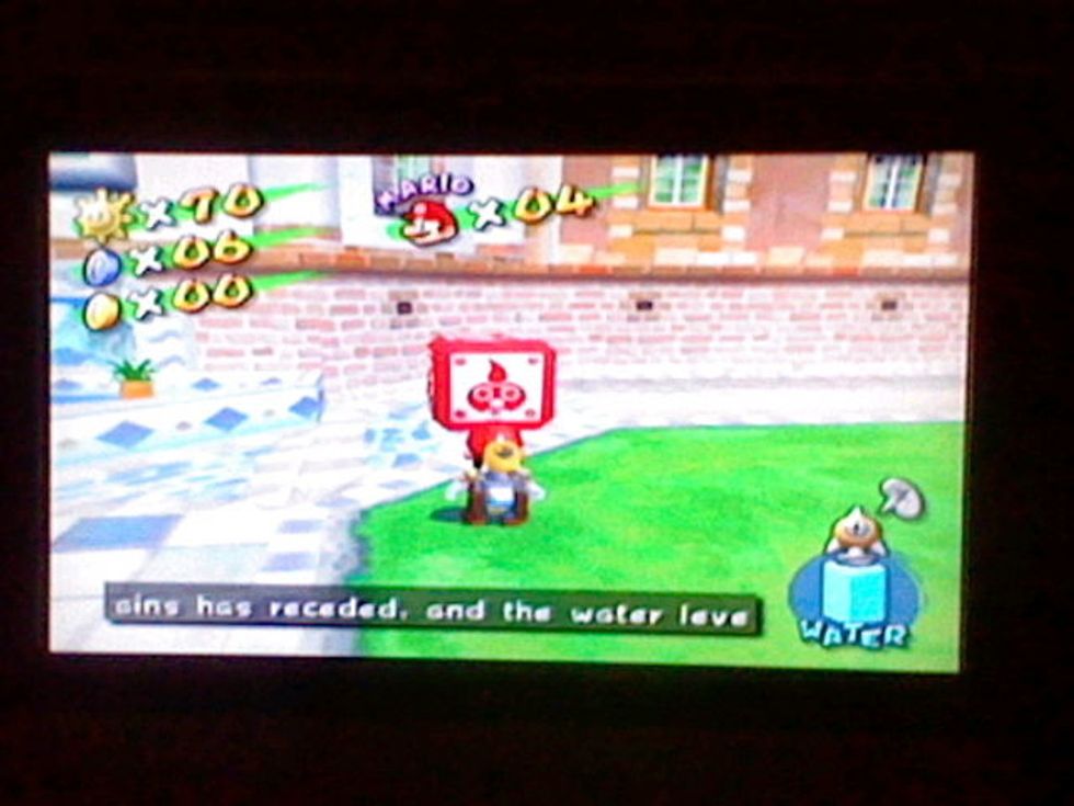 Go to the Delfino Plaza and find the red box. Proceed to stomp on it.