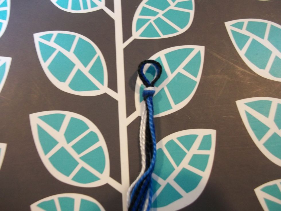 Go to the middle of the strings and tie a small loop.