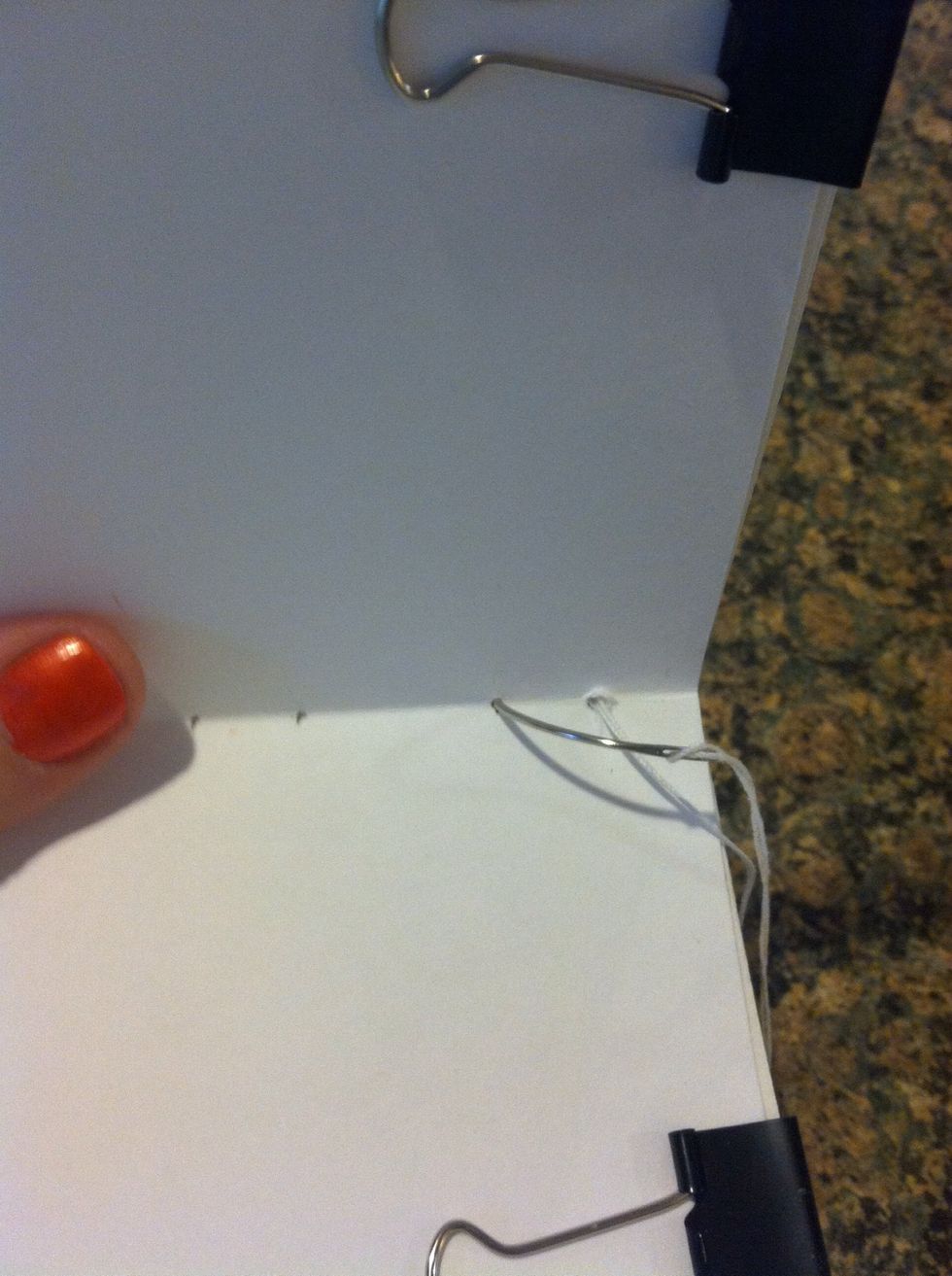 Go to the next signature, push needle through, pull tight