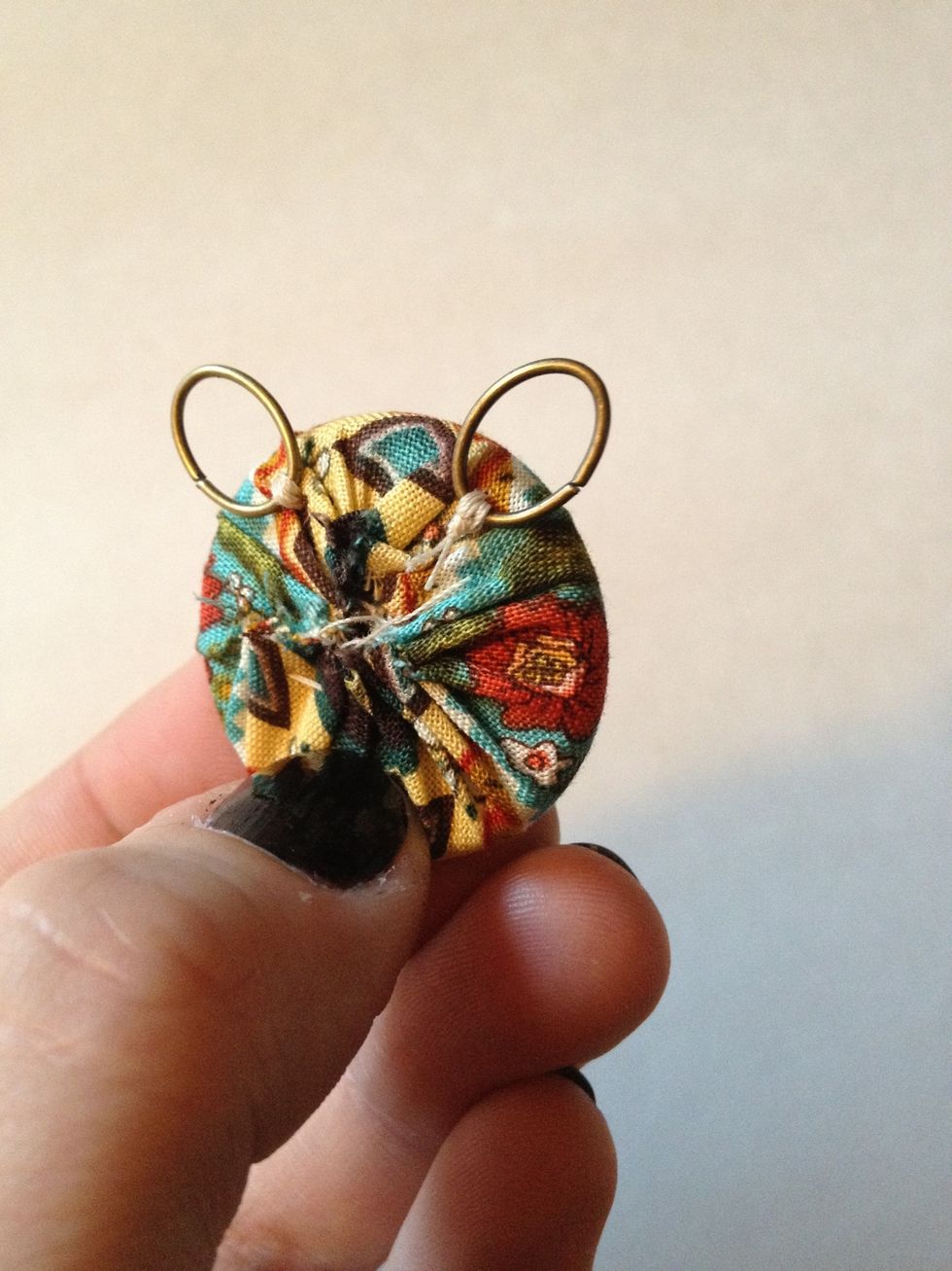 Go under fabric and emerge on other side (right of center). Repeat step 5 and knot off.