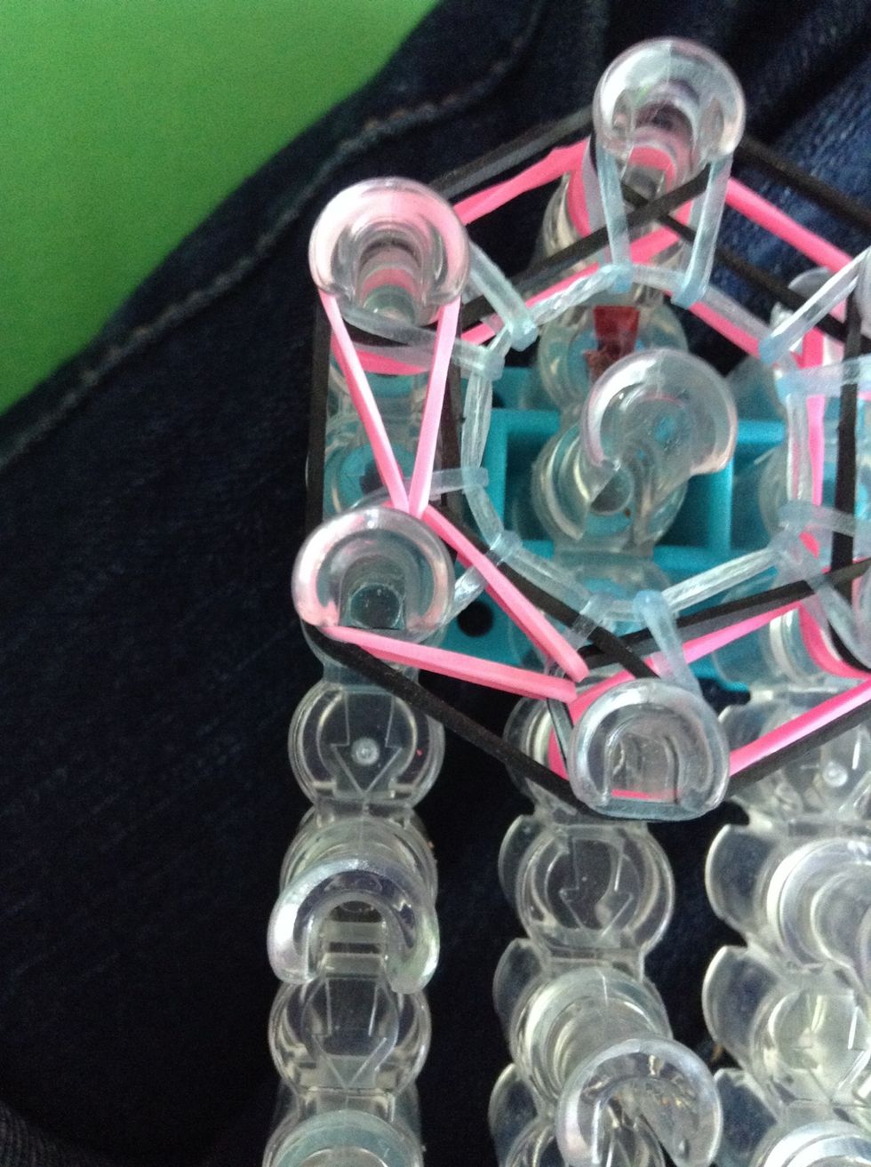 Go under the bands on the peg you just put the other part of the band on band take the bottom one and bring it forward. Do this all the way around.