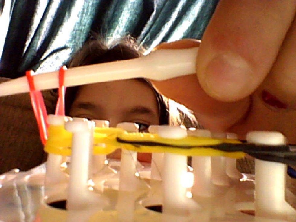 Go under the bands then grab another band and pull it thorough