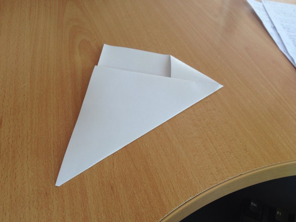 Golf right along the middle-base part of the triangle, and fold the remaining end back on top the triangle