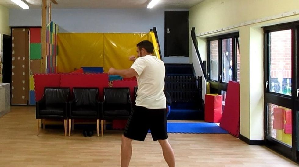 "Gotcha!" Shrink back immediately after, ready to follow up. As the foot plants, it is also turned outwards (outside edge facing opponent). This will assist driving back to the normal stance.