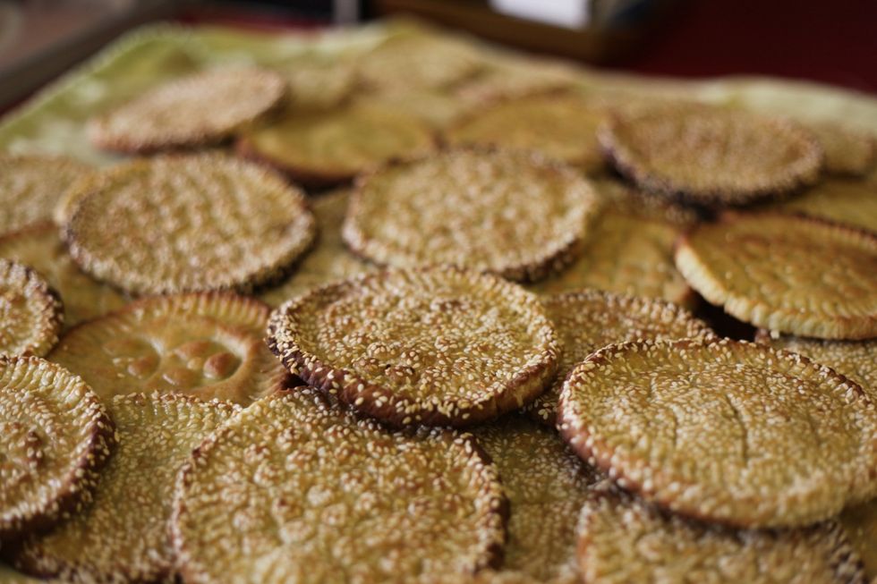 Grab 1 cup of milk, add 1 tablespoon of rose water and using a brush just cover the biscuit with the milk wash. Do this step while the biscuit is hot out of the oven.
