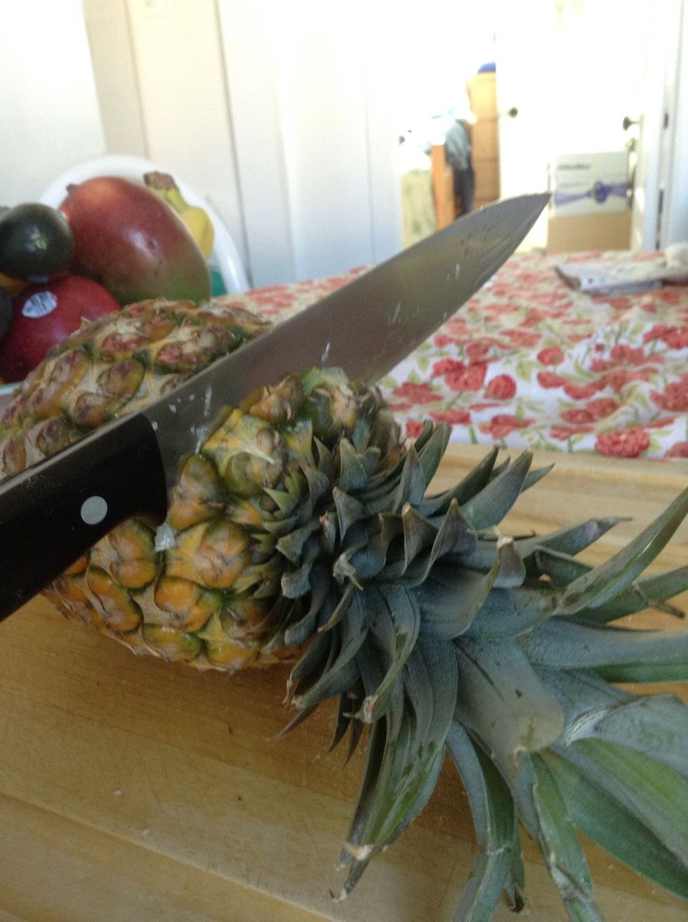 Grab a big sharp knife. First we cut off the top leaves.