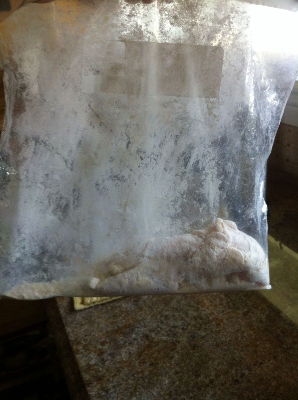 Grab a big zip lock and put the crushed garlic and coconut flour inside. Mix well and add chicken. Coat and shake off excess flour.