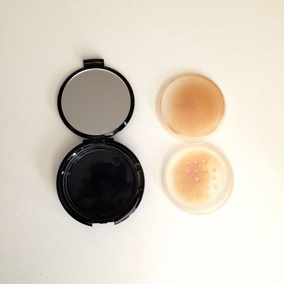 Grab a clean container or glass jar. I'm using an old mineral powder compact .