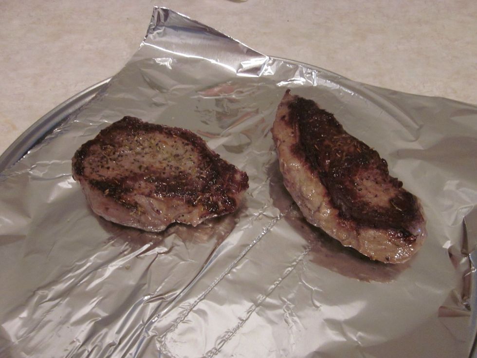 Grab a cookie sheet, put some foil down and put the steaks on it when side 2 is complete. Put it in the oven for the same amount of time as you did 1 side. They'll be ready after that!