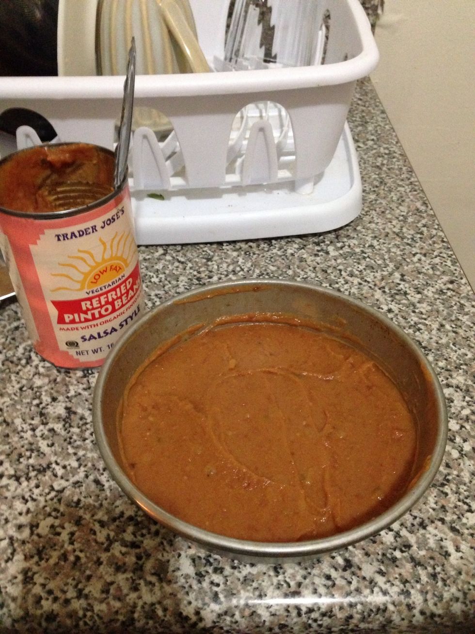 Grab a dish or pan you can bake in and layer the refried beans on the bottom. Not too thick or thin.. Also depends on preference. How much or little do you like? Remember this is a layered dish.