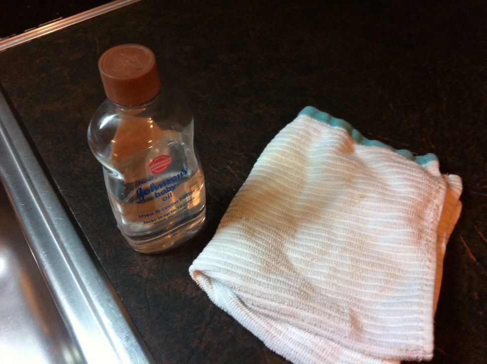 Grab a dry dish towel to apply Baby Oil and Buff it.