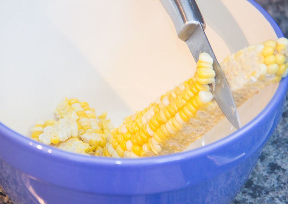 Grab a large mixing bowl and place the cob upright in the bowl with the stem side on the bottom of the bowl. Slice down the cob, allowing all the corn kernels to fall into the bowl.